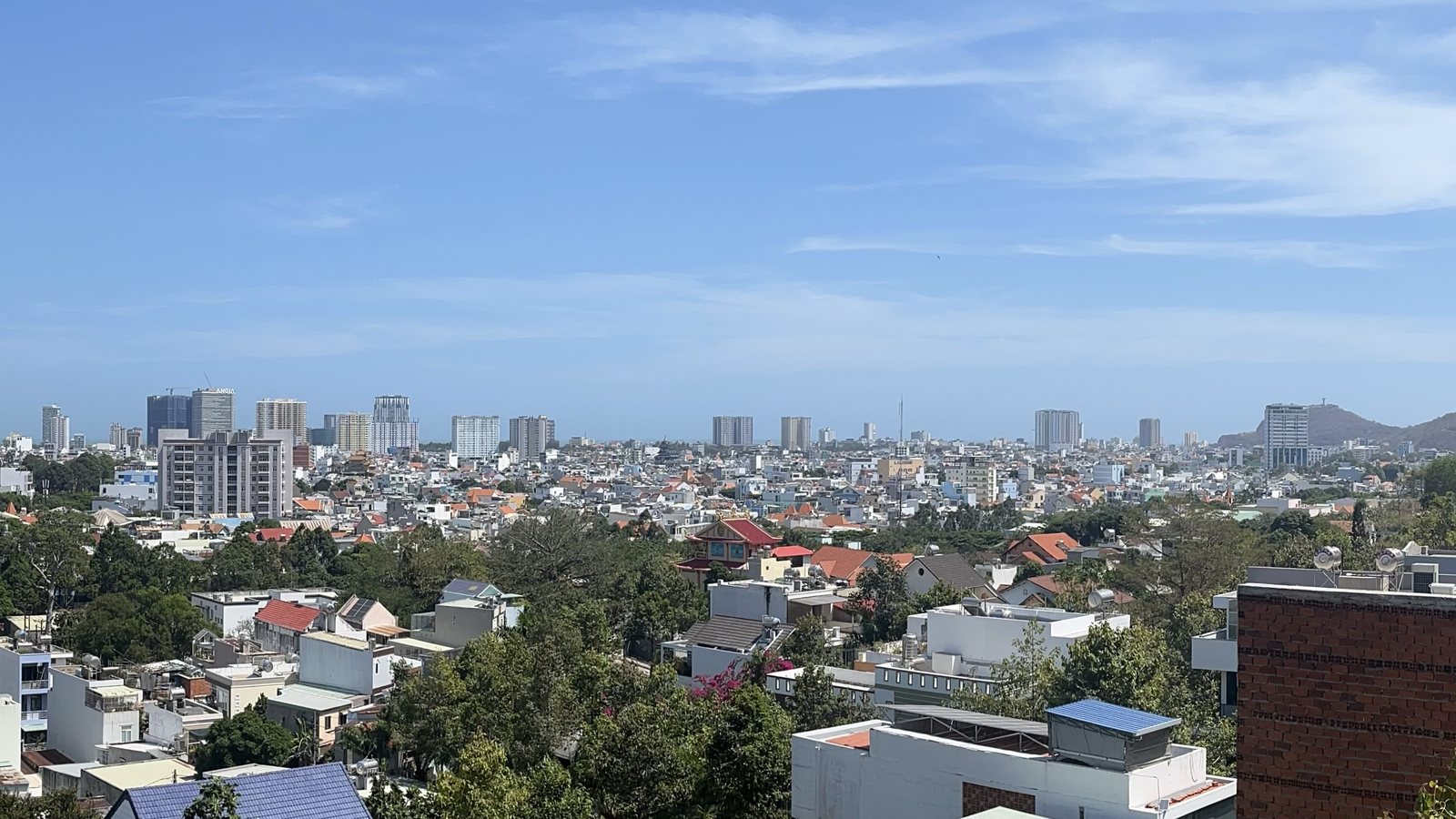 Vung Tau cityscape and coastline seen from above with calmer scale than larger Vietnamese cities